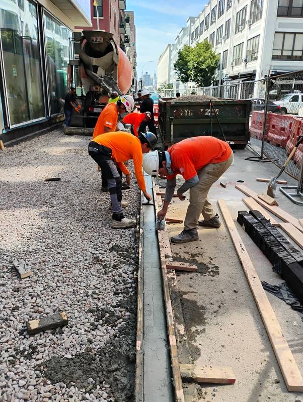 Crew setting forms and rebar for the new curb and sidewalk — Platinum Concrete NY