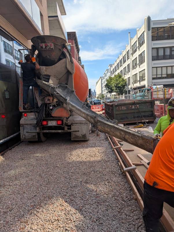 Ready-mix truck pouring the new sidewalk straight from the chute — Platinum Concrete NY