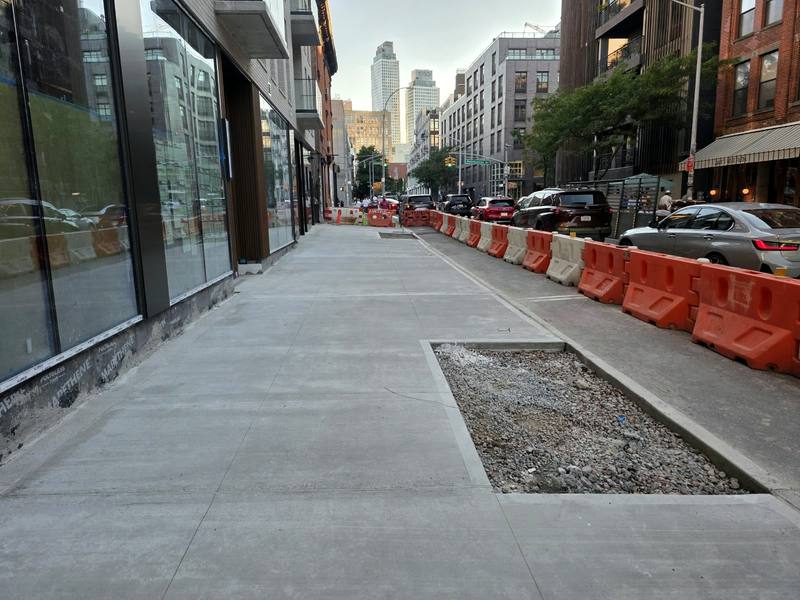 Finished concrete sidewalk with tree pit along the building — Platinum Concrete NY